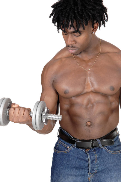A close up image of an African American man standing shirtless.and working out with his dumbbell, isolated for white background. - 写真・画像
