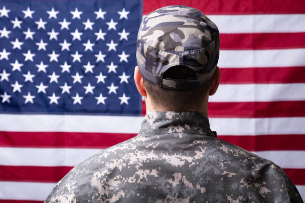 Rear View Of Soldier In Front Of Us Flag - Фото, изображение