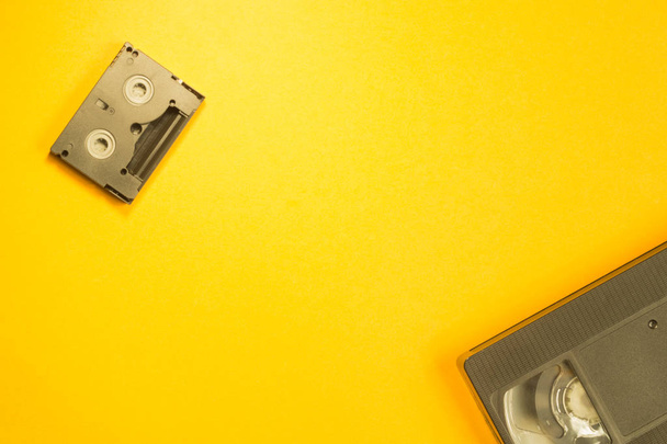 Video cassette on yellow background. mini cassette. copy space - Fotoğraf, Görsel