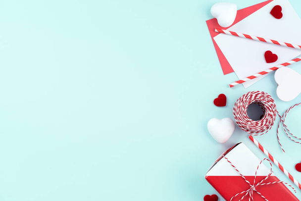 Valentine's Day, Mother's day art design concept for promotion - Red, white wrapped gift box isolated on pastel light blue color background, flat lay, top view. - Fotoğraf, Görsel