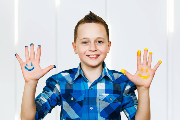 Studio Portrait Of Young Boy With Painted Hands - Fotó, kép