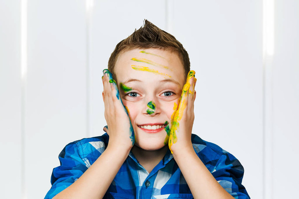 Studio Portrait Of Young Boy With Painted Hands - Фото, изображение
