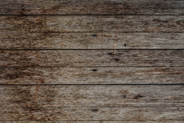 Close-up of wall made of wooden planks. Old dark brown wooden wall background texture. - Foto, imagen
