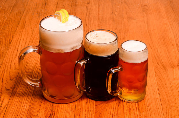 Variety of different beers, of different colors and alcoholic strengths in different shaped glasses suited to different personalities - Photo, Image
