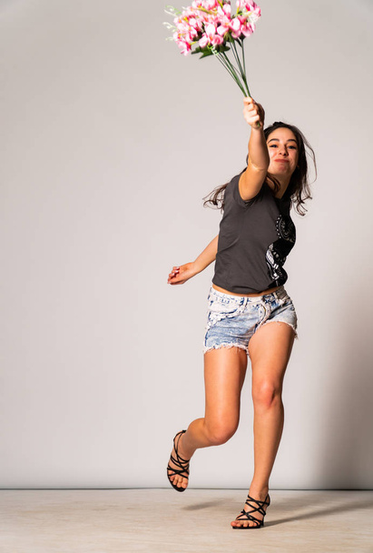 Krásná brunetka model ve stylovém oblečení pózování v světlé místnosti  - Fotografie, Obrázek