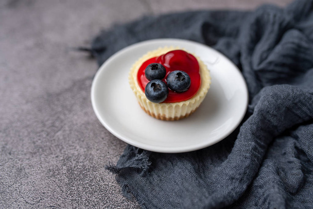 Mini cheesecake with blueberry and cherry topping sweet summer treat - Photo, Image