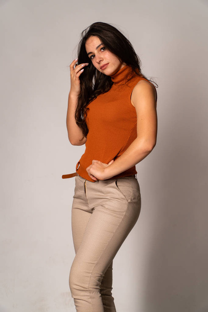 Beautiful brunette model posing in dark room  - Фото, зображення