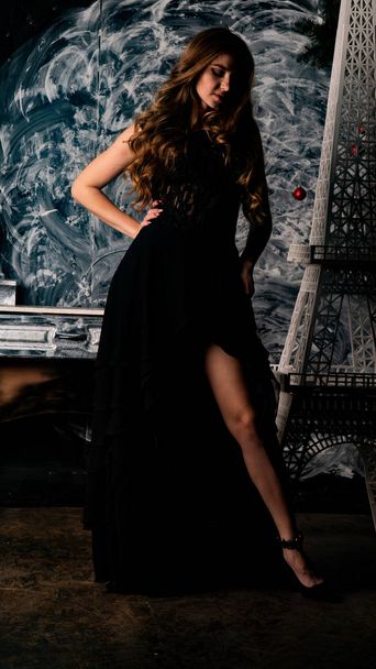 woman in delicate black dress posing in studio   - Foto, Imagem