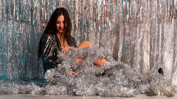 beautiful sexy woman in shiny christmas tinsel posing in studio, holiday concept    - Fotoğraf, Görsel