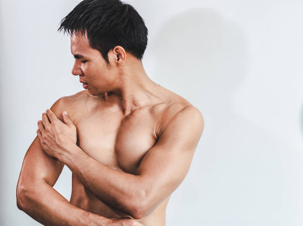 Asian man with muscular arm injury. From exercise on White backg - Fotó, kép