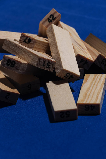 Pila de Bloques de madera sobre mesa en color aarl clsico con luz dura y sombras marcadas y los cubos de madera estn numerados
 - Фото, изображение