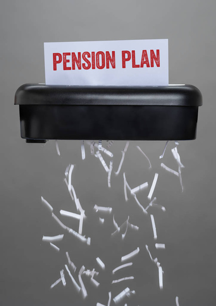 A shredder destroying a document - Pension Plan - Photo, image