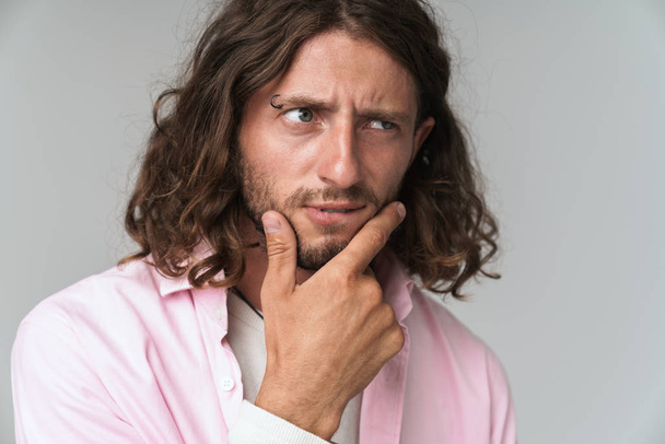 Close up of a young long haired man wearing shirt - Foto, immagini