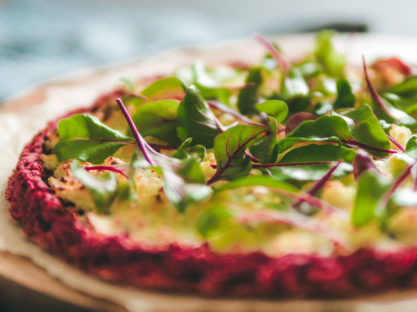 beetroot pizza crust with fresh swiss chard or mangold, beetroot leaves. Ideas and recipes for vegan snack.Egg-free pizza crust with chia seeds and wholegrain brown rice flour. Copy space. Shallow DOF - Photo, Image