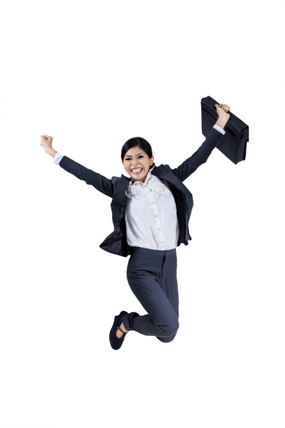 Happy businesswoman jumping with a briefcase - Фото, зображення