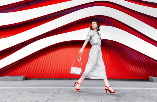 Active woman in heels at the red wall - Foto, Imagem