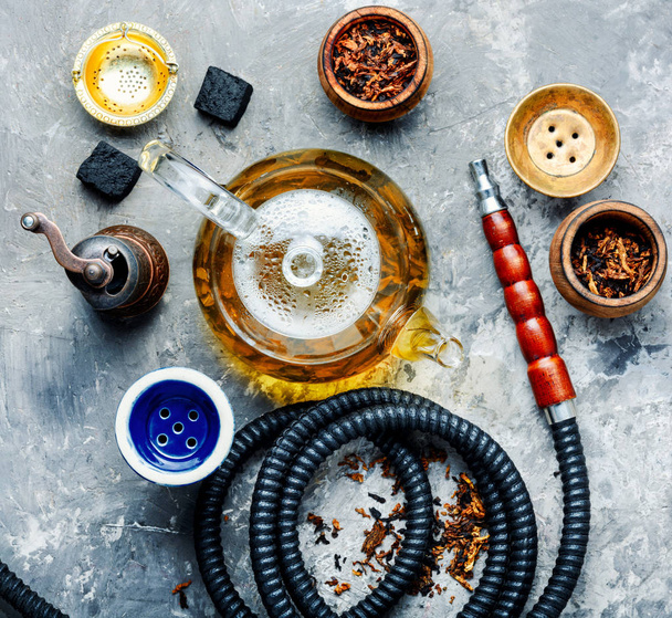 East smoking hookah. Arabian shisha with tea. Hookah and tea. - Foto, Imagen
