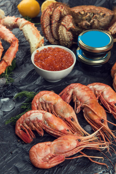 Set of seafood: red and black caviar, limb of hairy crab, limb of snow crab, far eastern kamchatka crab - Fotoğraf, Görsel