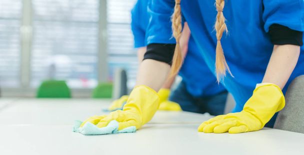 Close-up of cleaning team working in an office - Photo, Image