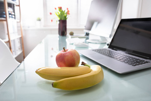 Apple And Laptop On Desk In Office - Fotoğraf, Görsel