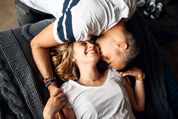 Young couple in love laughing in bed - Фото, изображение
