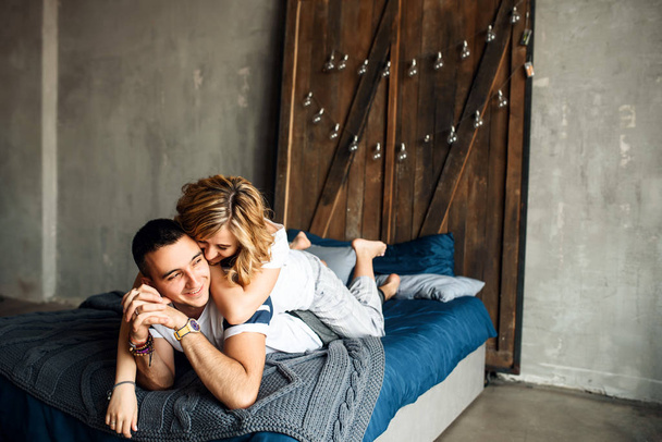 Young couple in love laughing in bed - Fotografie, Obrázek