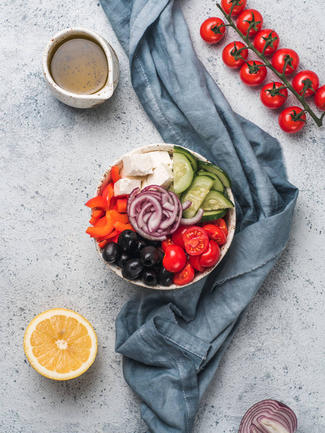 Greek Salad Bowl on gray cement background, copy space. Above view of Bowl Greek Salad. Trendy food. Idea, recept and concept of modern healthy food. Vertical. - 写真・画像