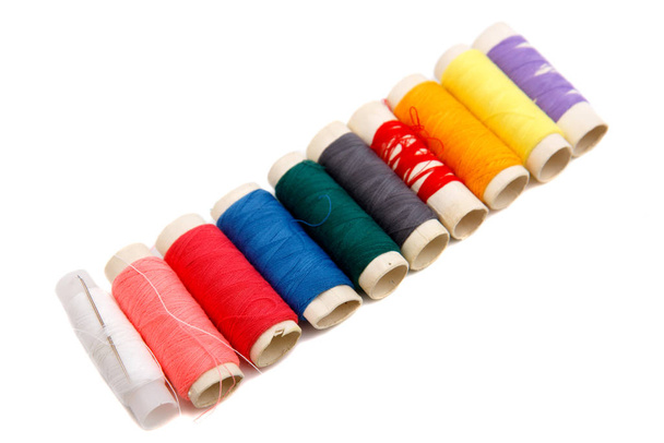 Many colorful thread spools on white background - Fotografie, Obrázek