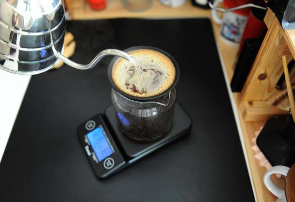 Black porous ceramic paperless coffee filter on glass jug. Gooseneck kettle. Electronic scale. Manual brewing still life - Fotoğraf, Görsel