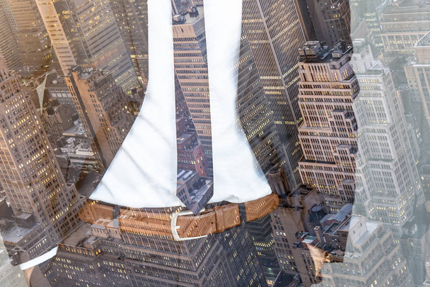 Corporate business, entrepreneurship and economic prosperity conceptul collage. Businessman wearing fashionable classic navy blue suit against new york city buildings and skyscrapers. - 写真・画像