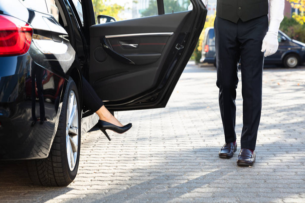 Close-up Of A Woman's Feet With High Heels Getting Out From Car - Foto, afbeelding