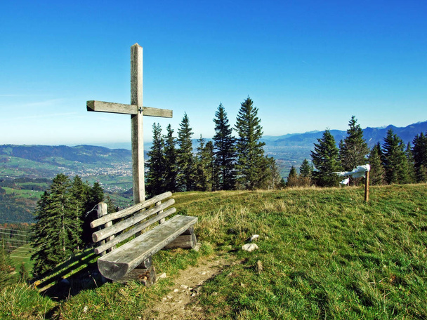 Christian crucifix on the slopes of a Alpstein mountain range and in the Rhine river valley (Rheintal), Oberriet SG - Canton of St. Gallen, Switzerland - Photo, Image