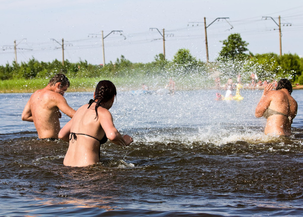 young people jump and splash around in the Lake - Fotoğraf, Görsel
