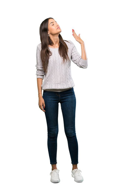 A full-length shot of a Young hispanic brunette woman with tired and sick expression over isolated white background - Photo, Image