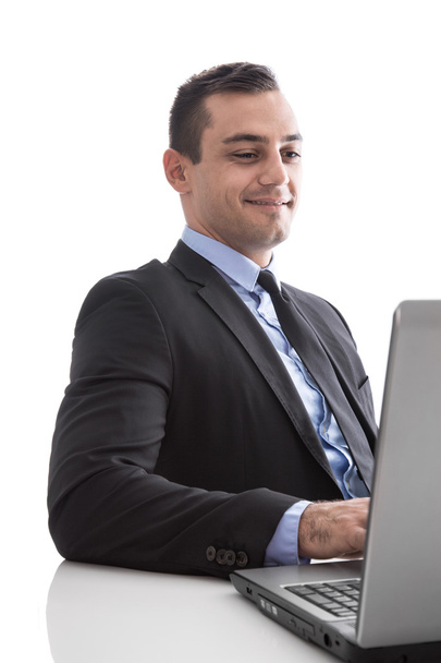Young business man looking satisfied with laptop isolated - Фото, изображение