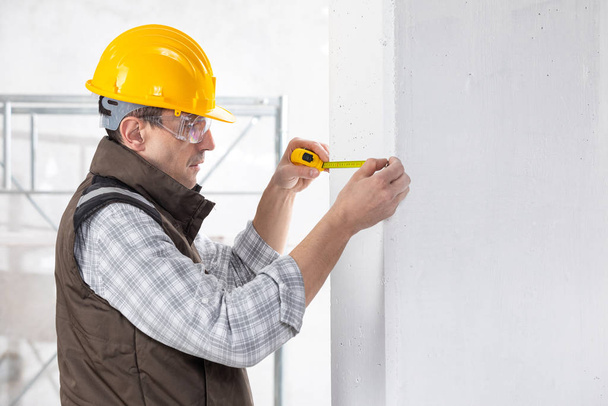 Builder marking off a measurement with a pencil - Photo, Image