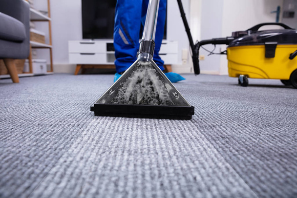Low Section Of A Person Cleaning The Carpet With Vacuum Cleaner In Living Room - Fotó, kép