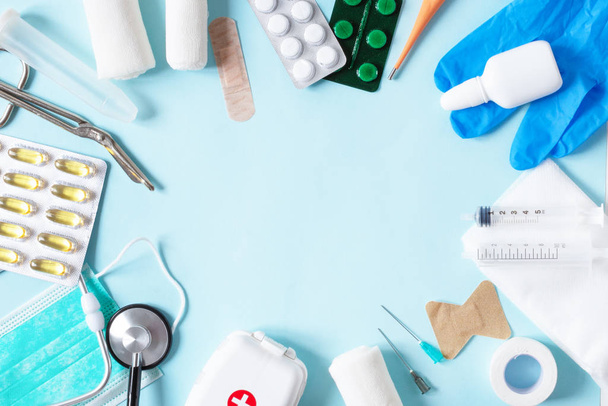 Medical equipments with stethoscope, scissors, syringes and other objects on blue background top view. - Photo, Image