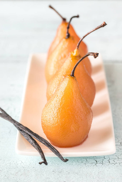 Poached pears in rose wine on the plate - Foto, Imagem