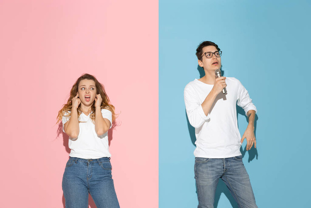 Young emotional man and woman on pink and blue background - Foto, immagini