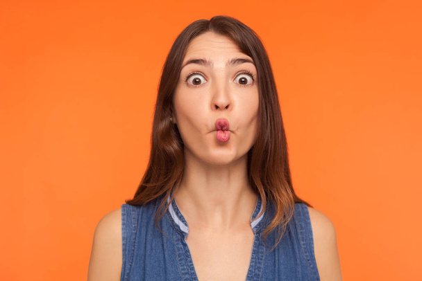 Closeup of funny stupid brunette woman making fish face, looking - Foto, imagen