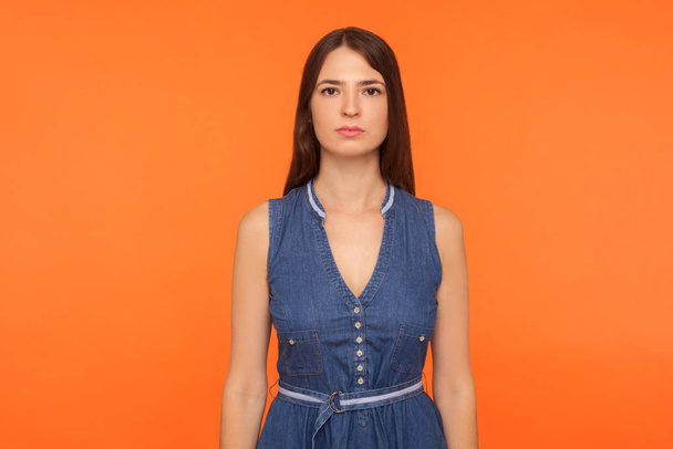 Beautiful brunette woman with big brown eyes and in denim dress  - Фото, изображение