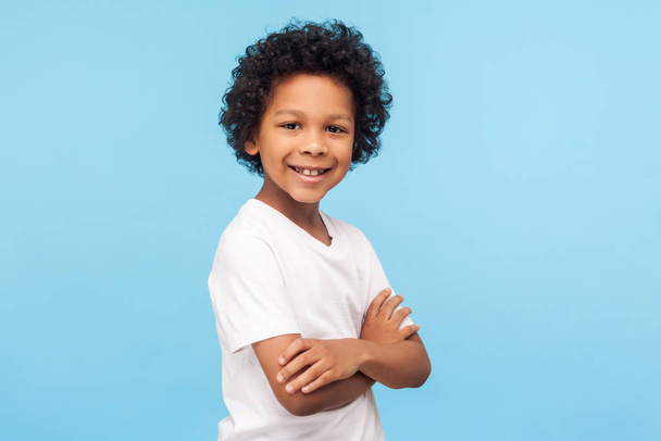 Portrait of happy and confident little boy in white T-shirt stan - 写真・画像