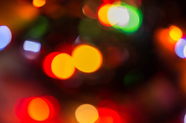 burning colored lights garlands on the background, blurred, out of focus, bokeh - Foto, Imagem