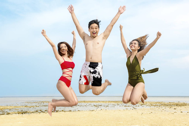 Group of asian friends having fun and jump together on the beach. Summer vacation - Фото, зображення
