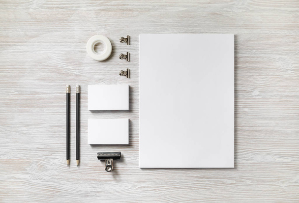 Blank corporate stationery set on light wood table background. Template for branding design. Flat lay. - 写真・画像