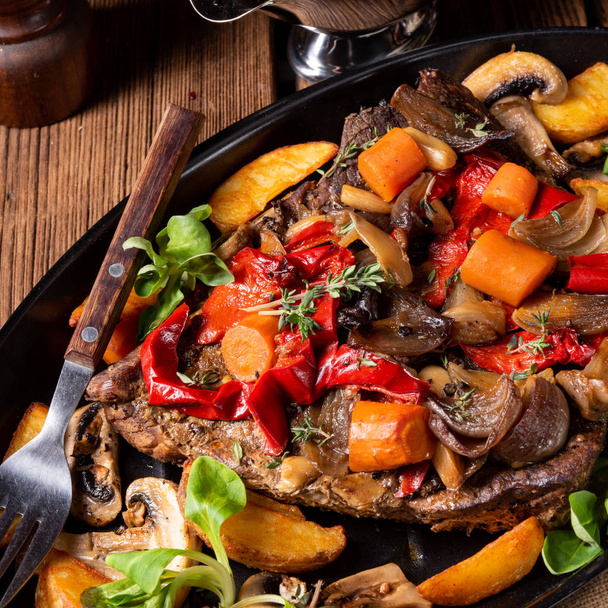 tender beef topped with various vegetables - Foto, afbeelding