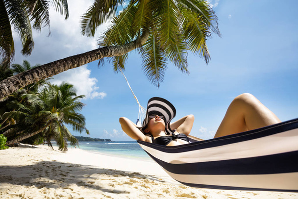 Close-up Of A Young Woman Relaxing On Hammock Over The Sandy Beach - Фото, изображение