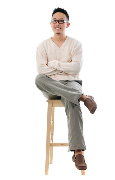 Asian male sitting on a chair - Zdjęcie, obraz