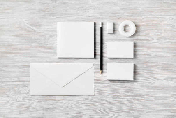 Blank stationery and corporate identity template on light wooden background. Top view. Flat lay. - 写真・画像